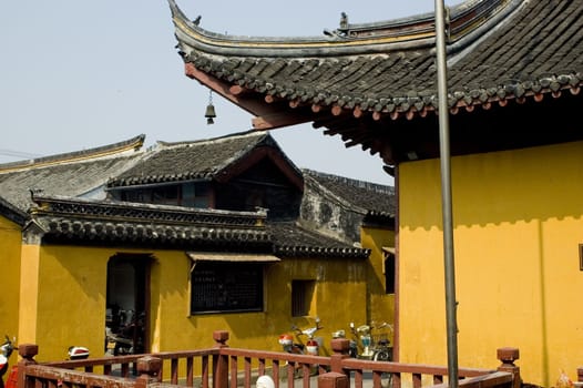 Traditional Chinese temple in Nantong city, Jiangsu province, China. Temple consists of few buildings, tower, monk's hostel and fireplace for incense. 