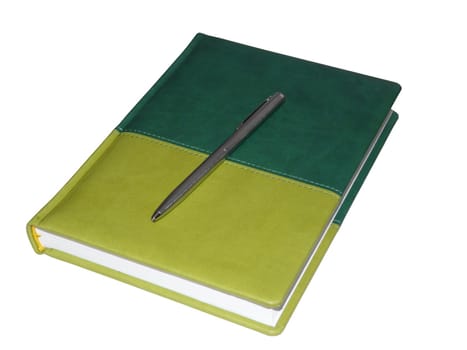 Green note book with silver pen on it