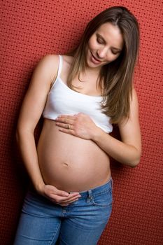 Beautiful pregnant woman holding belly