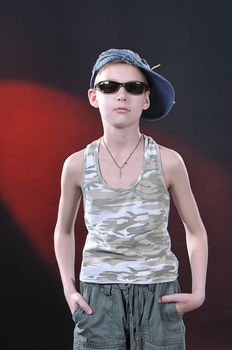 ten years old boy in a jean cap and sun glasses