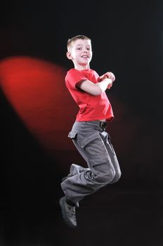 boy ten years in a jump on a dark background