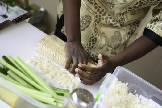 a sushi chef in action preparing a sushi dish