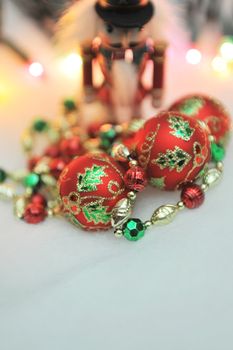 Red, green and gold Christmas decorations with lights in the background - shallow DOF.
