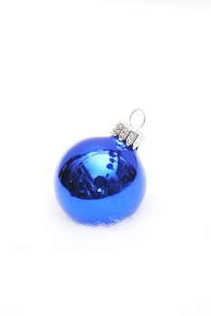 Singe blue ornament on a light fuzzy background