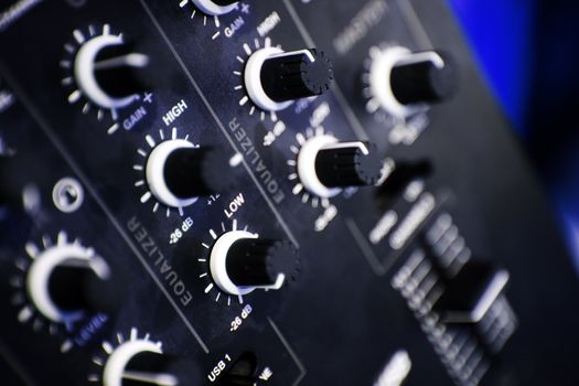 Close up of a panel control of a blue mixer table  in a studio