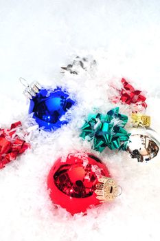Christmas decorations and colorful bows in snow