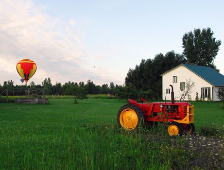 Hot Air Balloons over a field and an old tractor