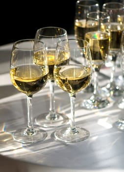 glasses of white wine illuminated by sunrays