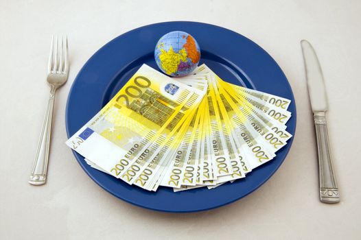 Euro money an small globe on the plate
