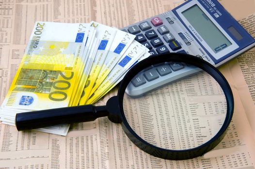Closeup of euros, calculator and lens and background of newspaper with stock rate  