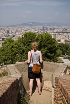 a girl looking over barcelone at castell de montjuic