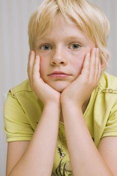 young cute blond boy thinking