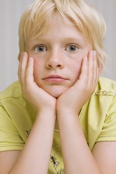 young cute blond boy thinking