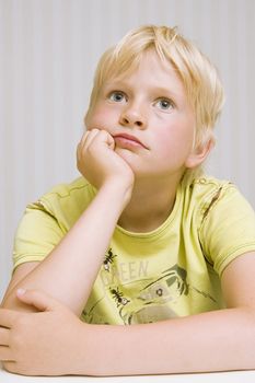 young cute blond boy thinking