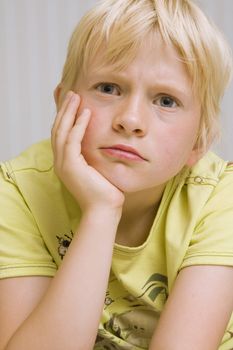 young cute blond boy thinking
