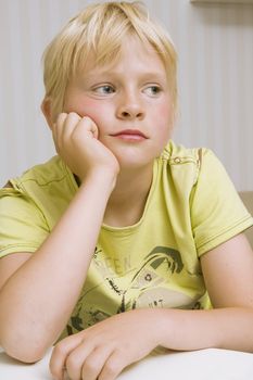 young cute blond boy thinking