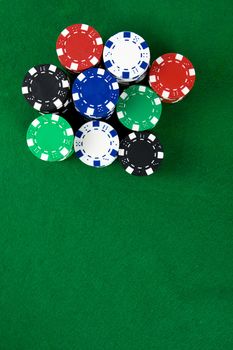 Stack of poker chips over green poker table
