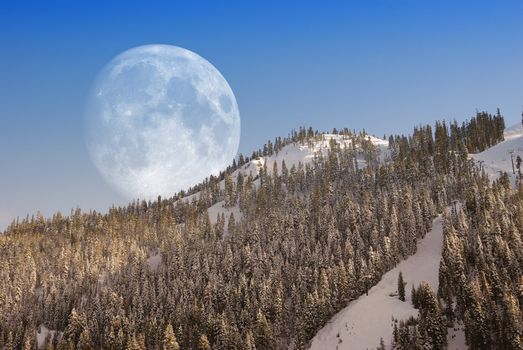 Big Moon over mountain in afternoon light.