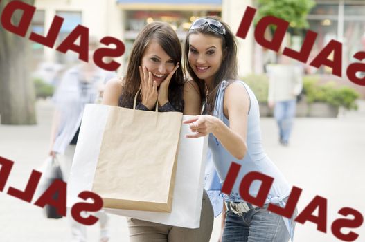 two girls looking at a shop window with a lot of interest