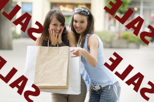 two girls looking at a shop window in sale with a lot of interest