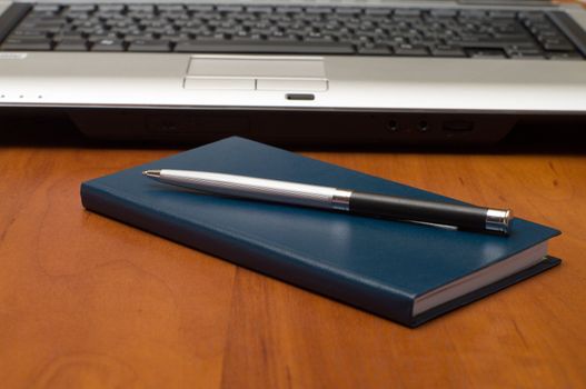 Notepad, pen and notebook on the desk close-up.