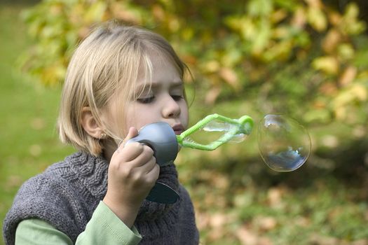 a little girl playing in the open air