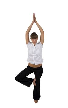 woman doing yoga on one leg in studio