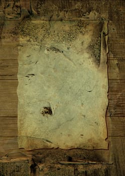 Worn parchment placed over a wooden background with crustyness