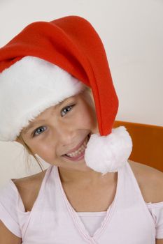 smiling cute little girl wearing christmas hat
