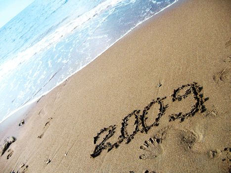 new year 2009 written on the beach sand