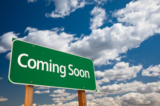 Coming Soon Green Road Sign with Copy Room Over The Dramatic Clouds and Sky.