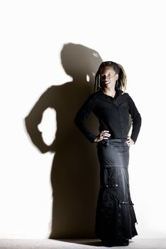 African American woman with dreadlocks against a white wall