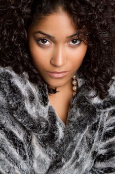 Beautiful black woman wearing fur coat