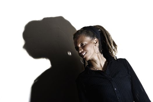 African American woman with dreadlocks against a white wall