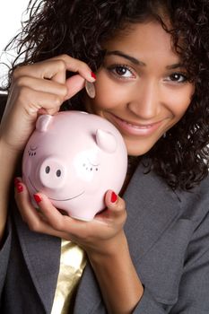 Beautiful woman saving money in piggy bank