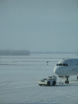 towed airplane in the winter