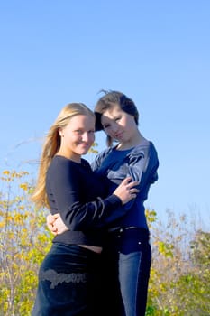 Two girlfriends in autumn park