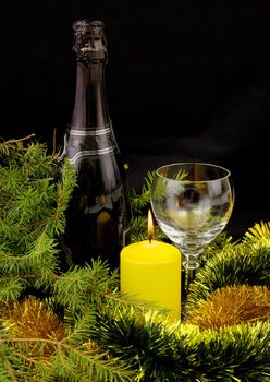 New Year's bottle of champagne, glass and candle