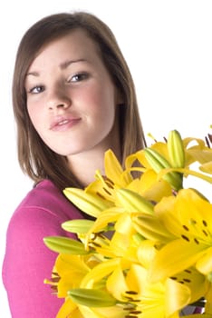 Beautiful girl with a bunch of yellow lillies; isolated on white.