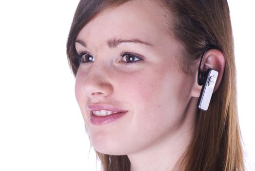 Teenage girl with headset isolated on a white background.