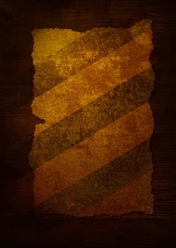 Piece of worn paper attached to a dark wood background