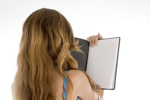 back pose of girl reading note book on  an isolated white background 