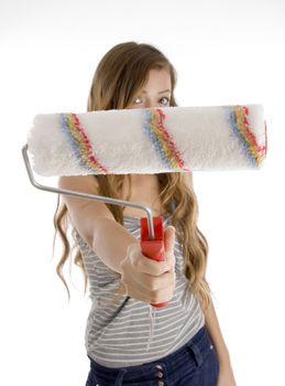 cute teen girl showing roller painting  brush to camera on  an isolated white background 