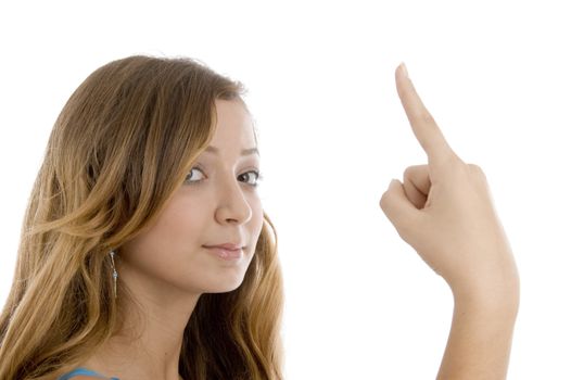 pretty girl showing index finger on  an isolated white background 