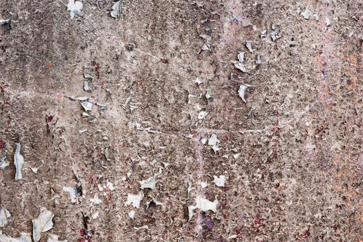 Dirty old stone wall with peeling paint rags