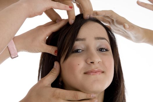 pretty teenager with many hands on her  on  an isolated white background 