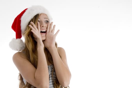 shouting young girl with christmas hat on  an isolated white background 