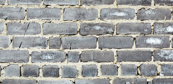 Detail of old moldy gray brick wall