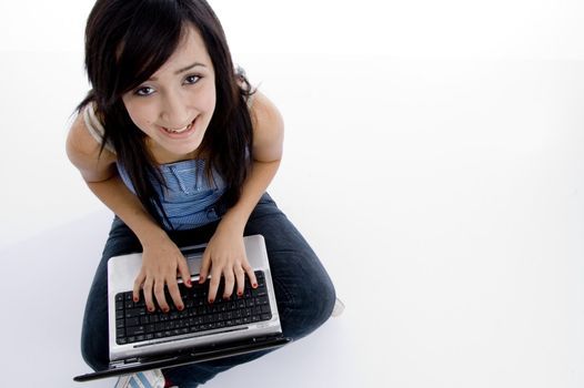 girl with laptop looking to camera on  an isolated white background 