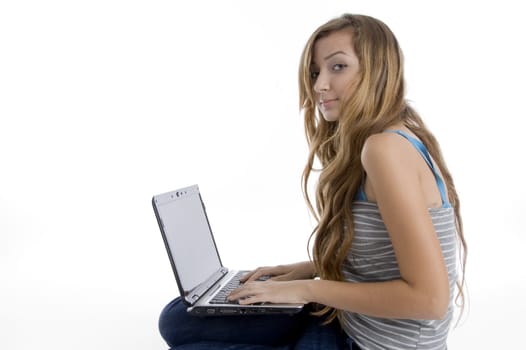 side view of girl working on notebook on  an isolated white background 